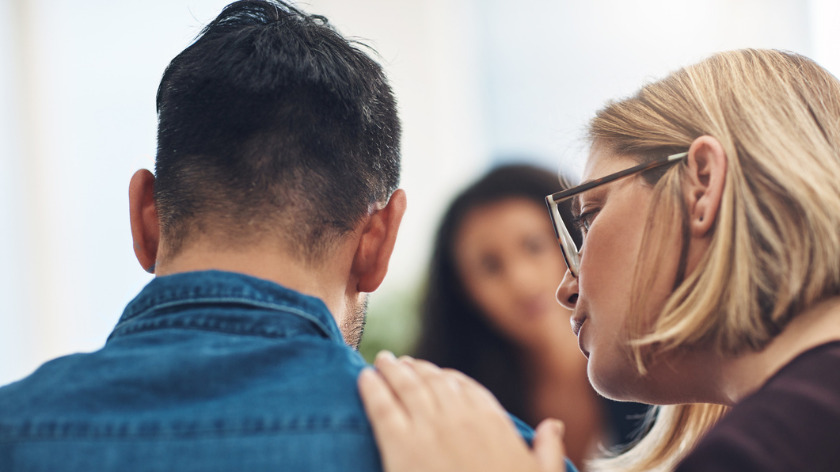 Woman consoling man at counseling therapy appointment - Vitality