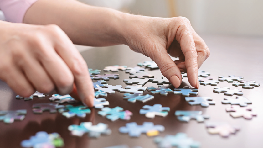 Woman doing a puzzle to solve productivity - Vitality