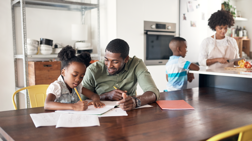 Family in kitchen cooking and doing homework routine - Vitality