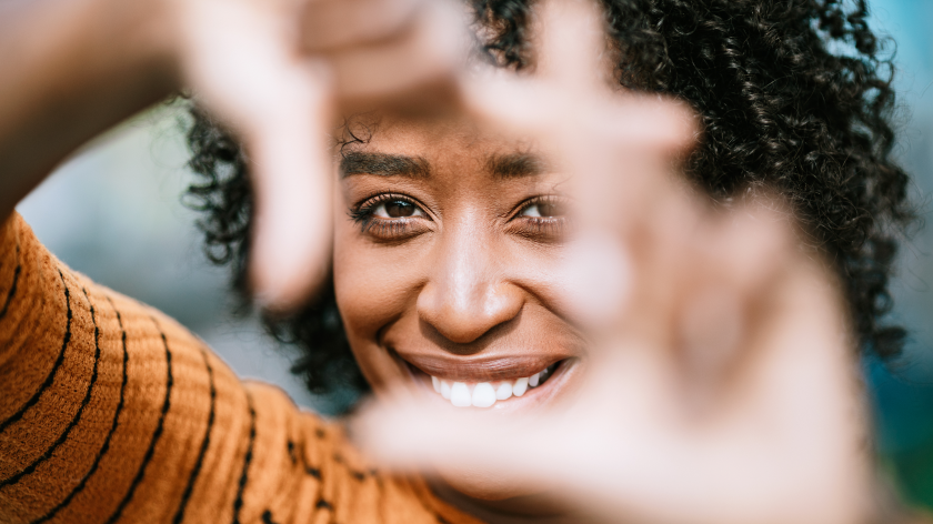 Woman looking into camera to frame a healthy mindset - Vitality