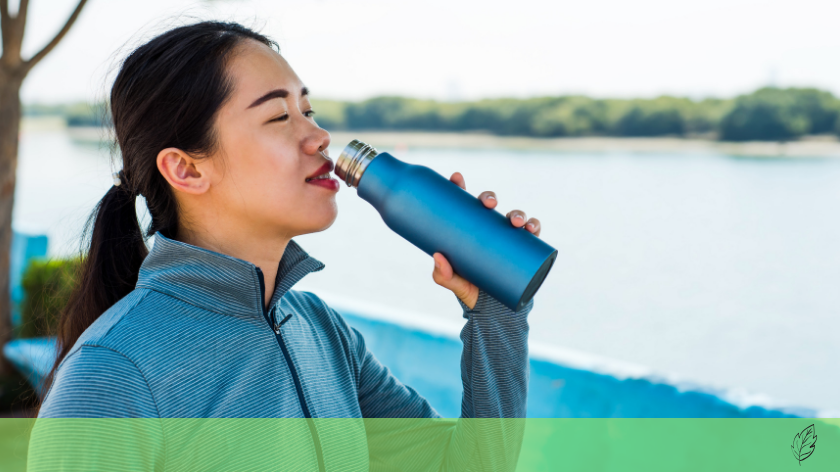 Woman drinking from reusable water bottle for low-waste workouts - Vitality