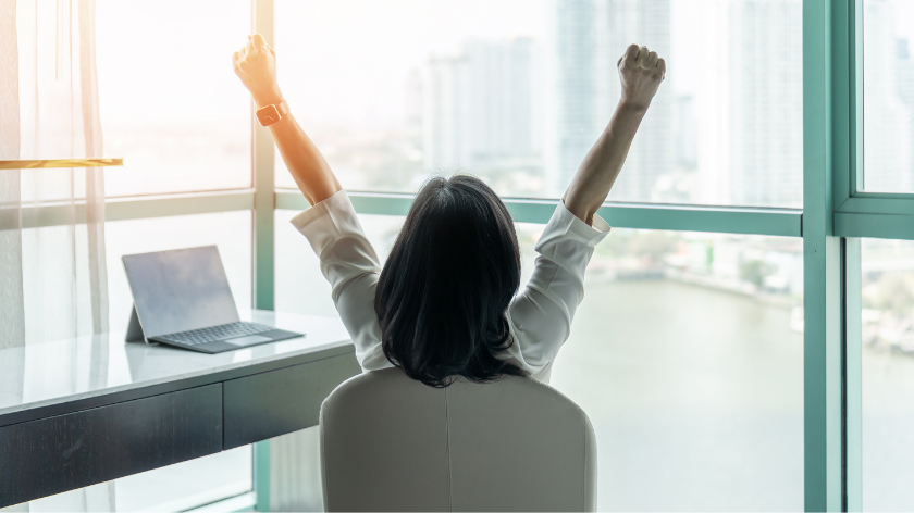 Woman celebrating a goal at work - Vitality