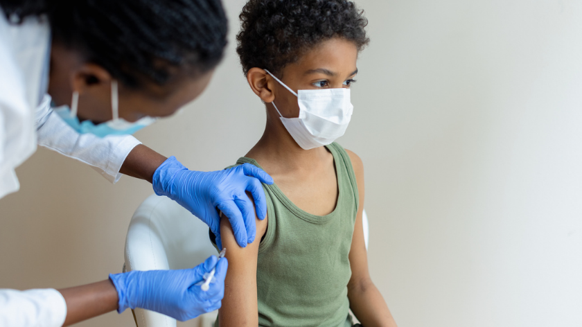 Boy gets vaccine from health professional - Vitality