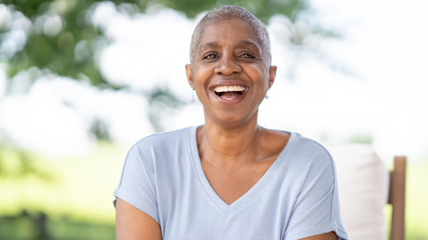 Senior woman smiling outdoors for surviving cancer - Vitality