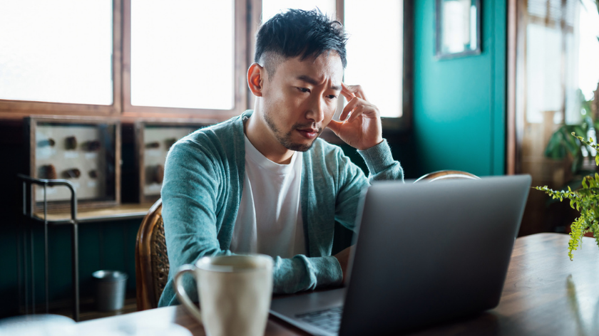 Man working on laptop looking stressed - Vitality