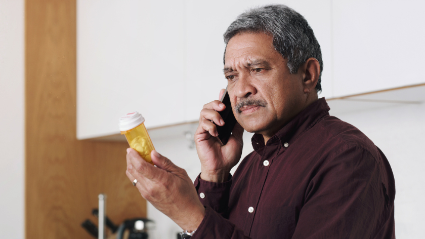 Concerned man on phone Prescription pill bottle - Vitality