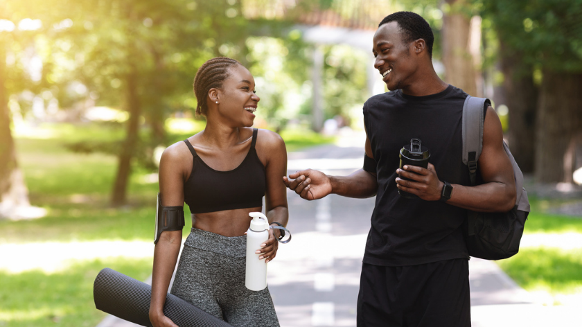 Two fit people outdoors smiling with exercise as medicine - Vitality