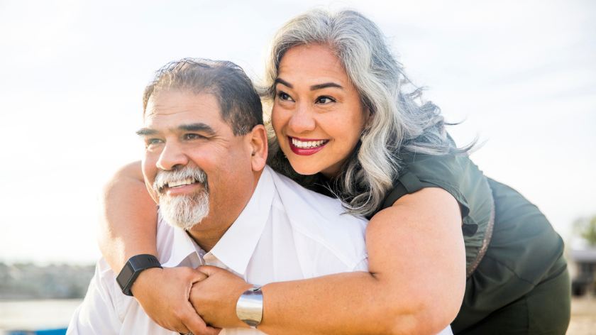 Couple embracing and smiling outdoors to find joy - Vitality