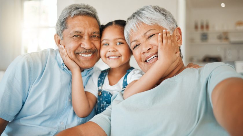 Grandparents and Granddaughter smiling for National Hispanic Heritage Month - Vitality
