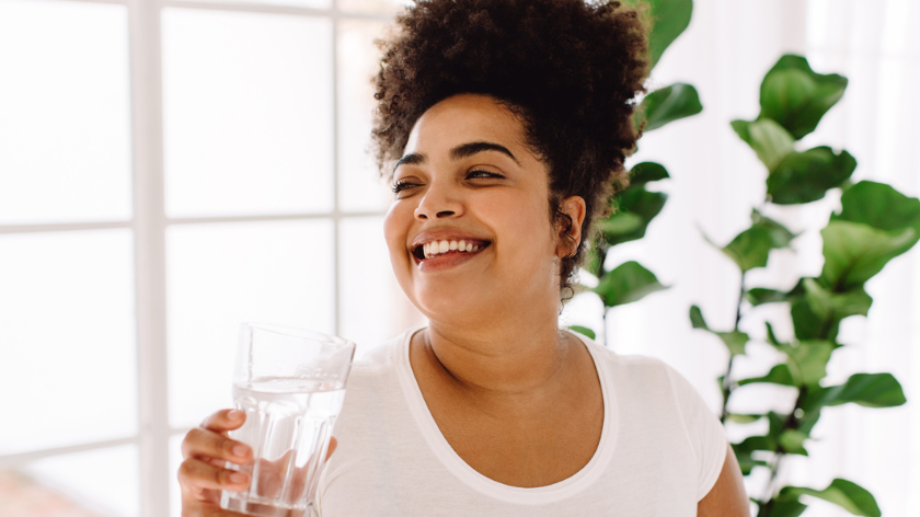 Women smiling and drinking water for hydration - Vitality