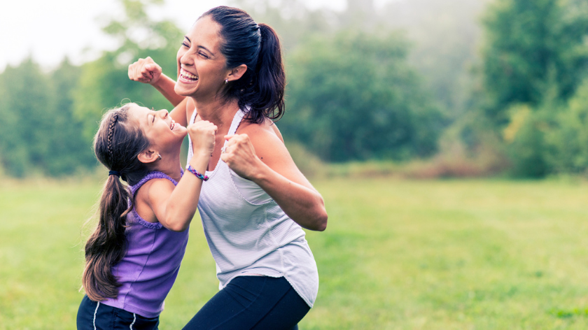 Mom and daughter laughing and playing outdoors to get the most from workouts - Vitality