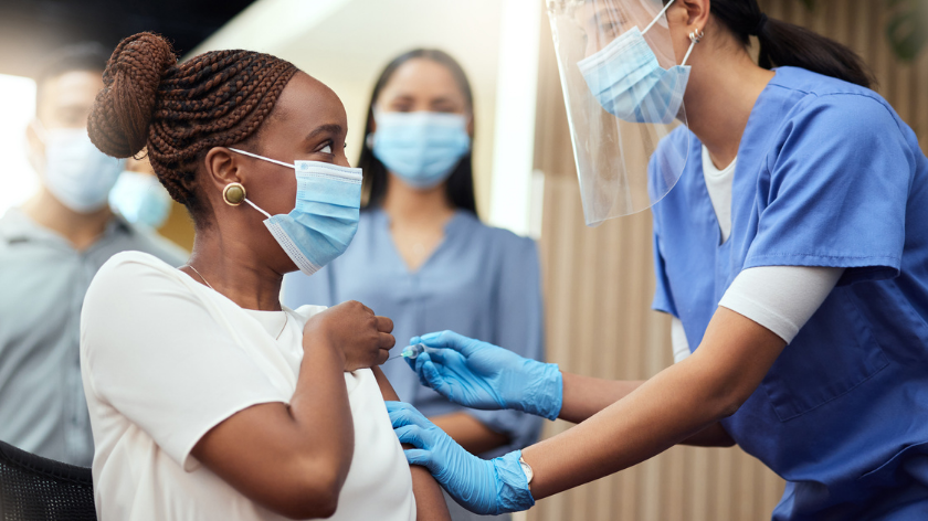 Health professional giving woman vaccine to protect health - Vitality