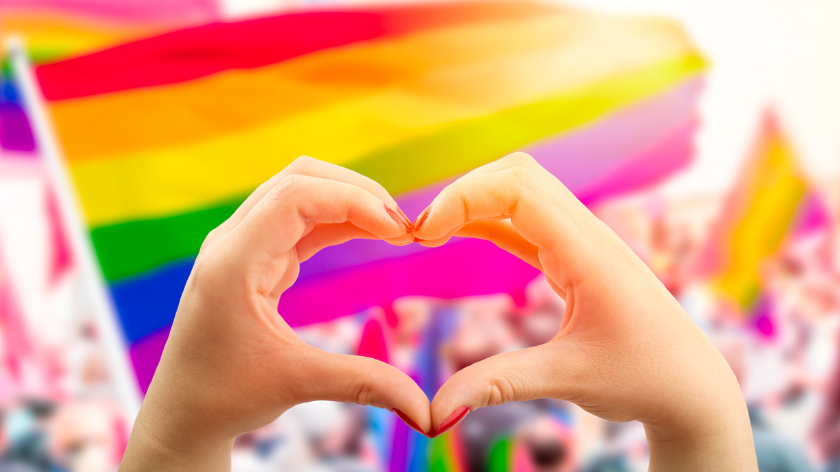 Heart hands for happy pride day event with rainbow flag - Vitality