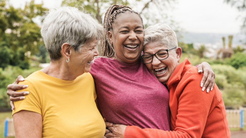 Three women embrace friendship and accepting whole self through positivity - Vitality