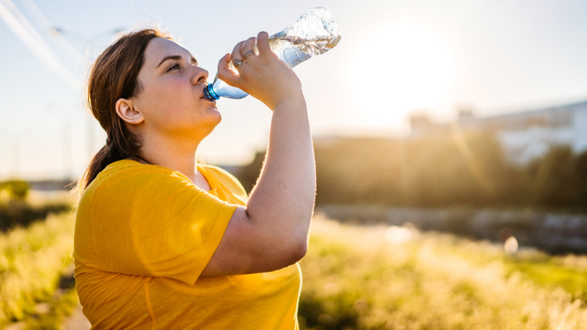 Woman drinking water to stay hydrated and healthy - Vitality