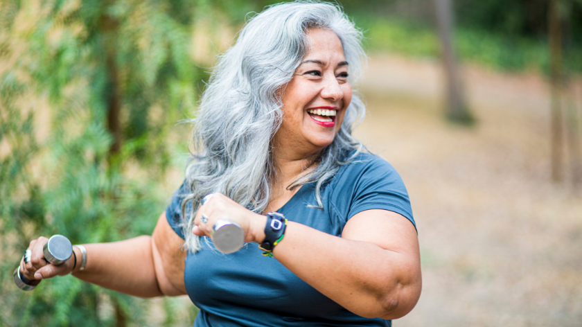 Women smiling while being active with weights outdoors to benefit mental health - Vitality