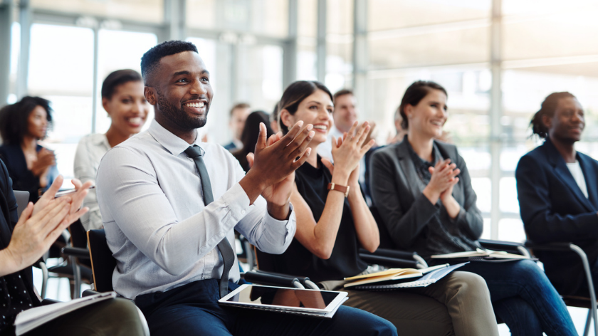 Group of professionals applaud after masterclass to support mental wellbeing - Vitality