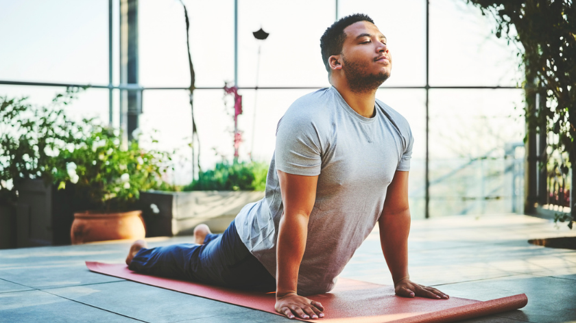 Man practicing yoga indoors because health is worth it - Vitality