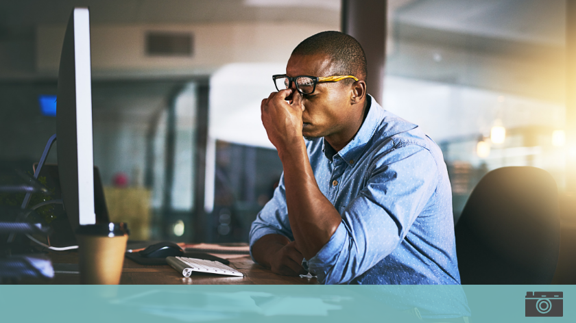 Stressed man at computer desk might be dying for a paycheck - Vitality