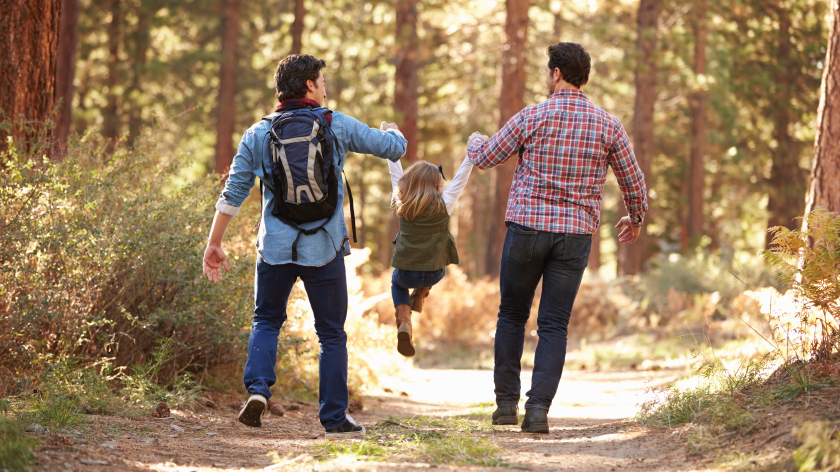 Dads doing some physical activity walking with daughter in woods - Vitality