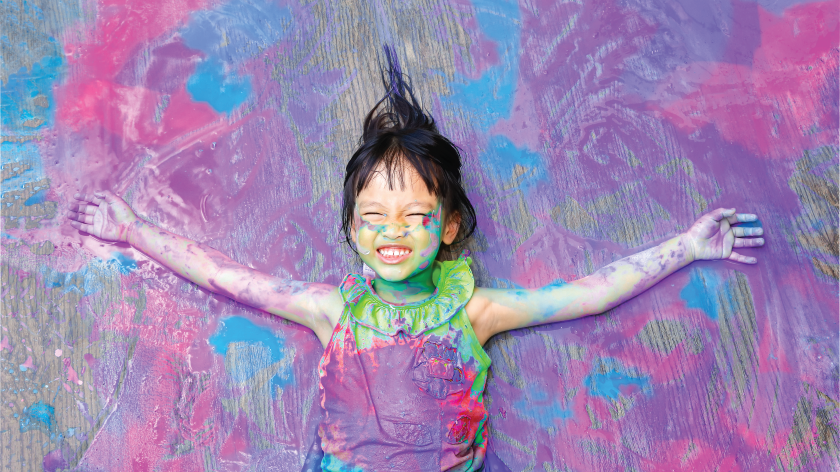 Girl with colorful paint smiling - Vitality