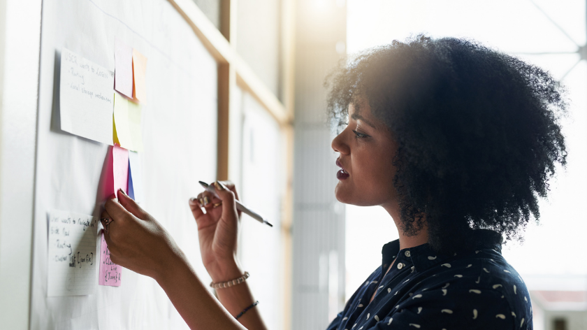 Woman taking notes to set goals and small steps - Vitality