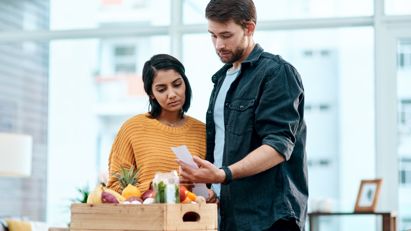 Couple looking grocery receipt for healthy eating on a budget - Vitality