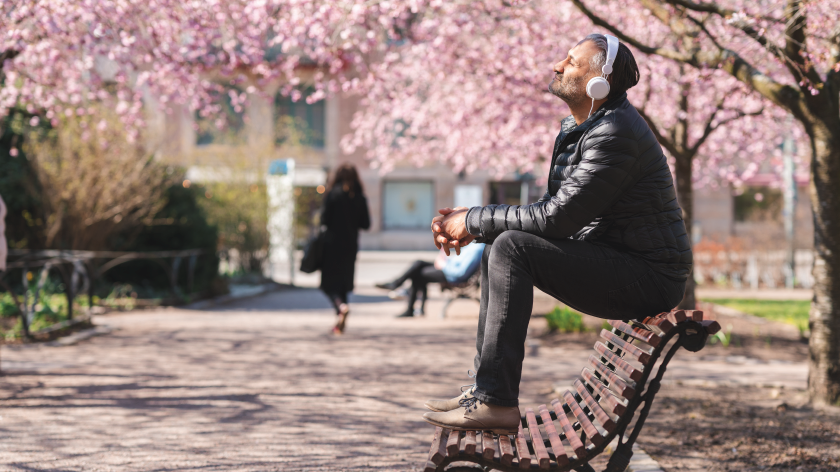 Man on bench outside in the spring reviving mental health with mindfulness - Vitality