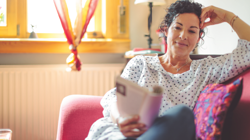 Woman reading on couch for Read Across America Day - Vitality