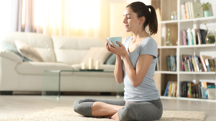 Woman recharges with warm beverage and meditation - Vitality