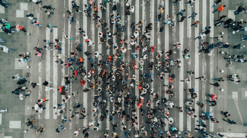 People walking in crosswalk on city street - Vitality