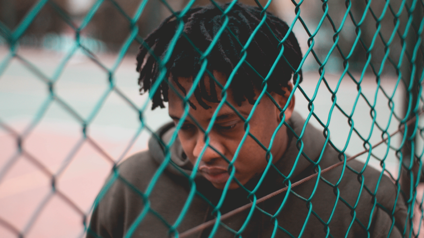 Man with fence thinking about setting boundaries - Vitality