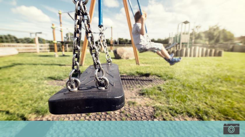Empty swing on playground with the World's youth not active enough - Vitality