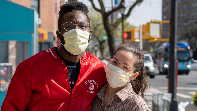 Couple outside on city sidewalk in face masks - Vitality