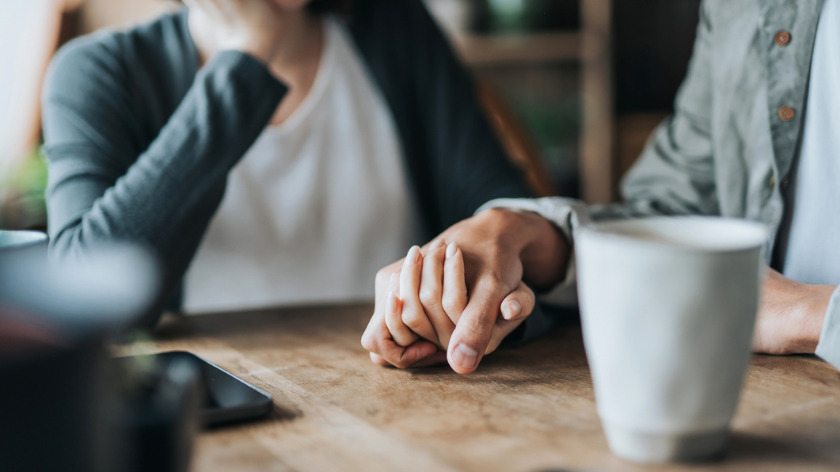 Two people holding hands to call on support - Vitality