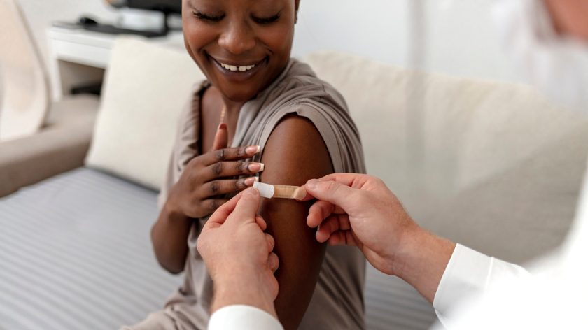 Woman patient gets vaccination flu shot from medical health professional - Vitality