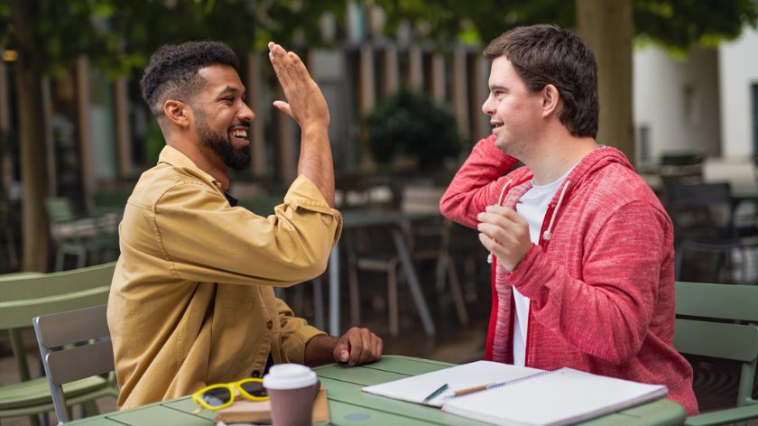 Friends high five outdoors sharing fun together - Vitality