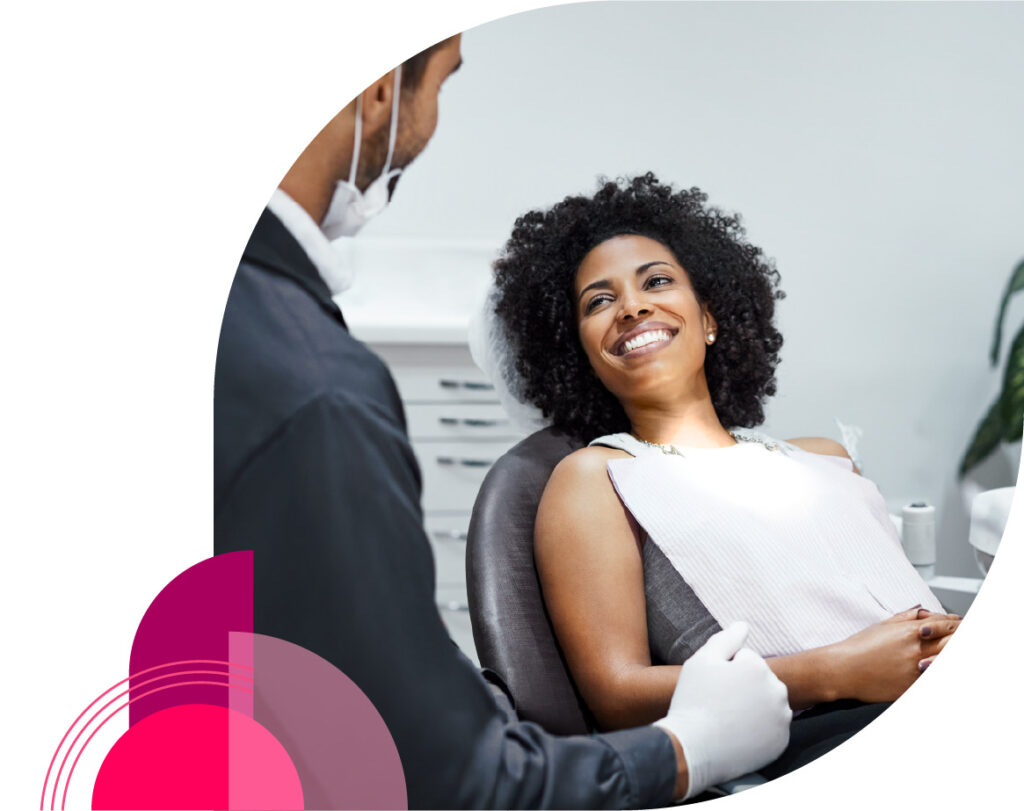 Woman smiling at dentist during dental hygiene cleaning exam - Vitality