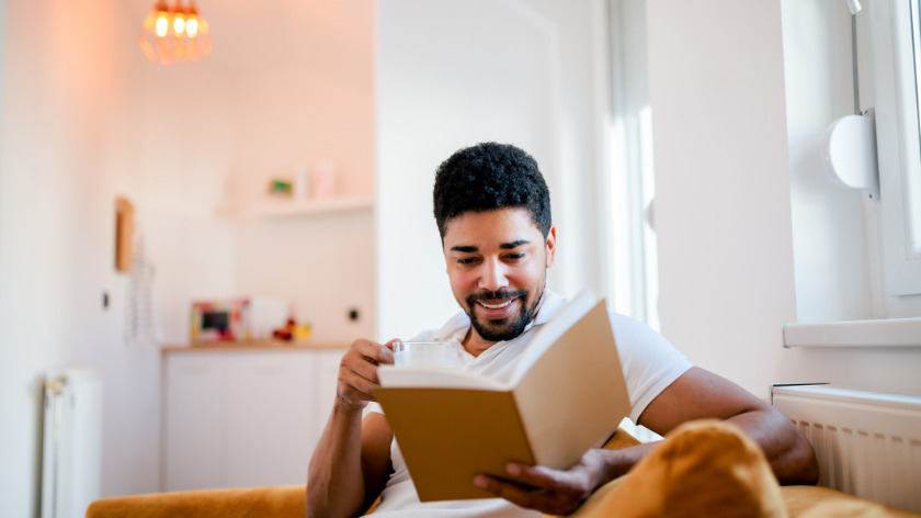 Man reading a book at home to get the facts - Vitality
