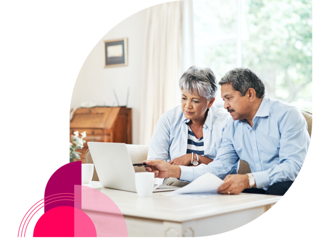 Couple using laptop at home reviewing information - Vitality