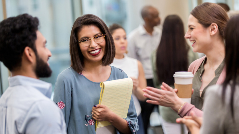 Professionals networking at a conference - Vitality