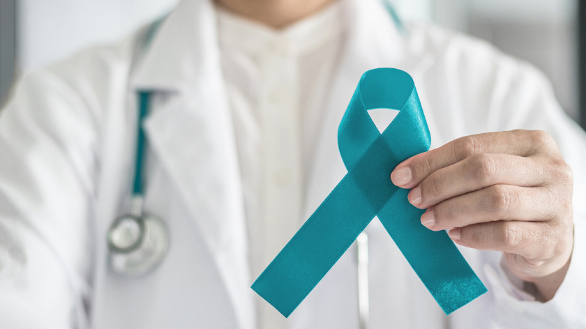 Doctor holding Cervical Health Awareness Month Ribbon - Vitality