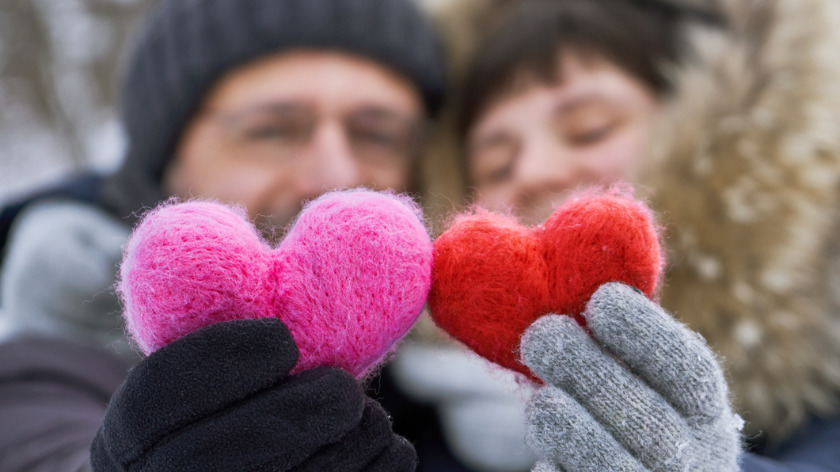 Holding red and pink hearts with winter gloves - Vitality